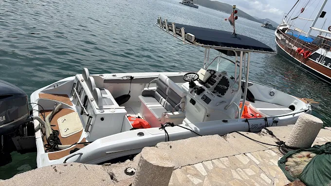 Aerial view of the Gloria Boat leaving a Saranda beach with guests on board